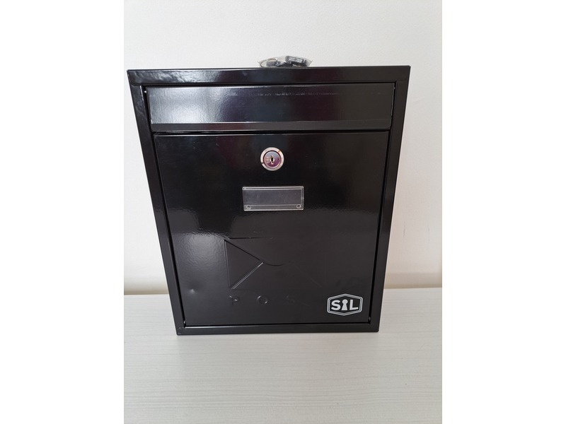Wall-mounted letterbox in Cowes